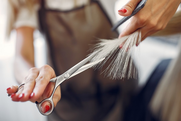Haircuts for Round Faces cut by a scissors