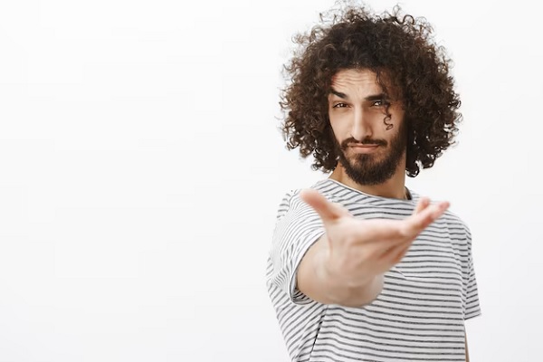 a young man with curls looking at the camera