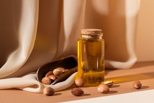 a bottle of argan oil together with its components