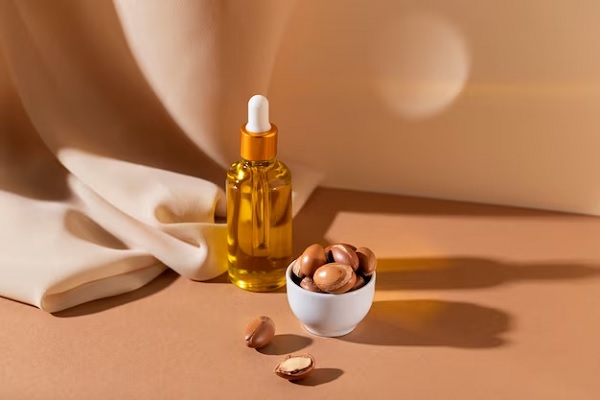 a picture of argan oil with argans in a cup