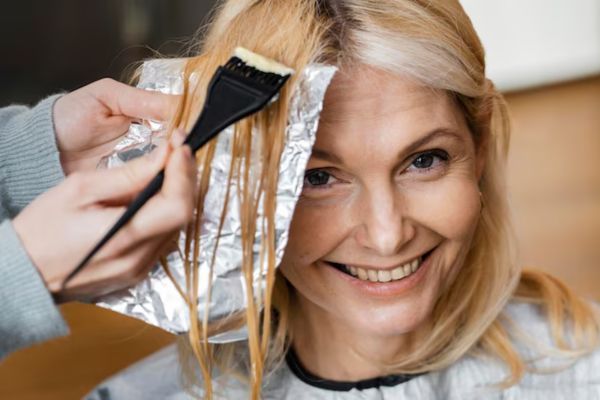 a woman dyeing her hair