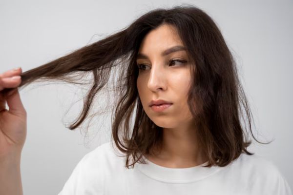a woman watching her hair loss
