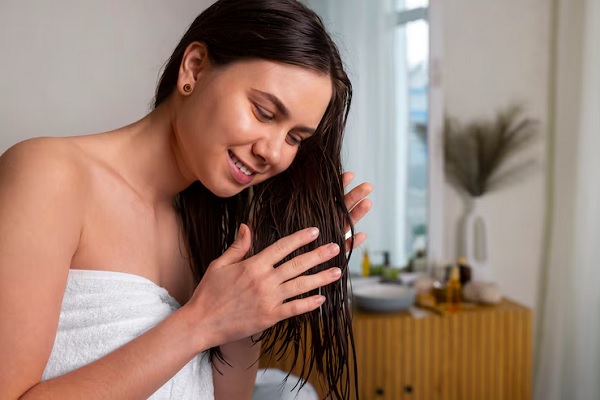 Woman doing night routine to recover burned hair