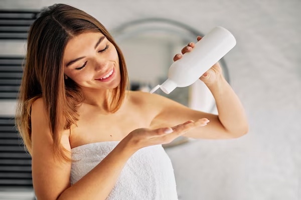 a woman using straightening hair conditioner