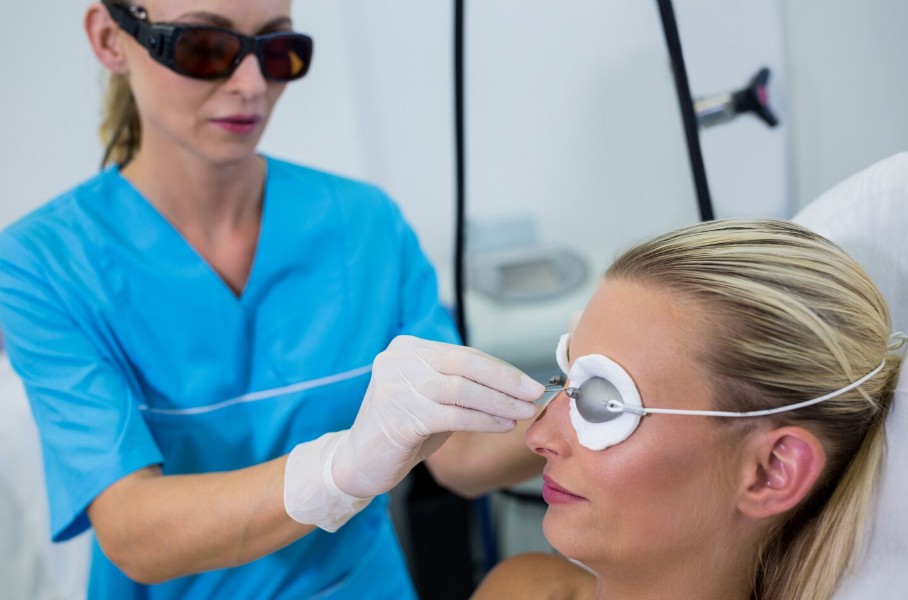 Dermatologist adjusting a protective glasses for hair laser therapy
