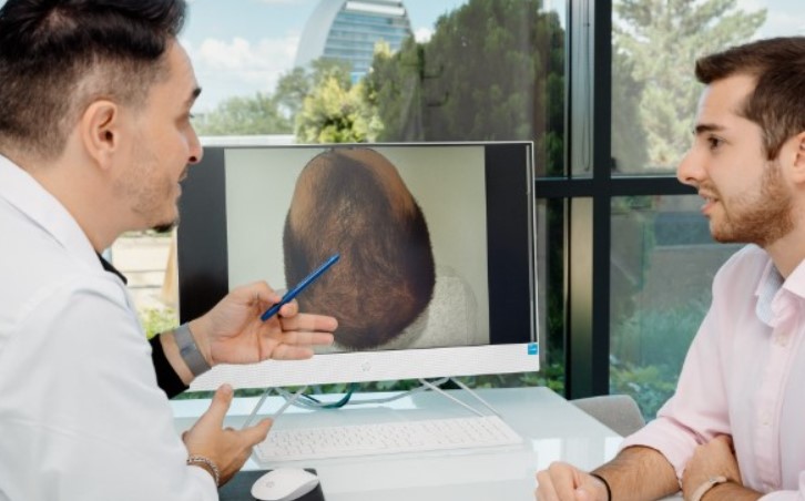 Man asking doctor if he can go to work after talking about hair transplant - hair transplant fees